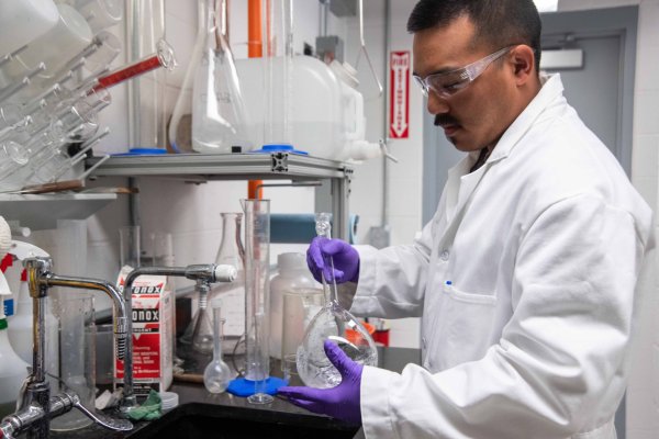Scientist with glassware in a laboratory