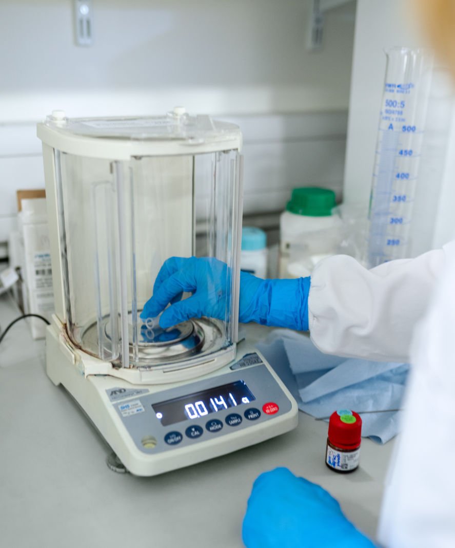 Scientists using a weighing balance